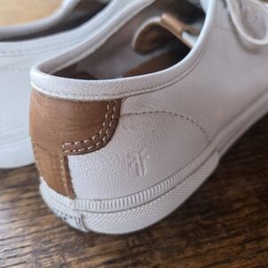 Frye Gia Low Lace sneakers in white leather with tan leather accents.